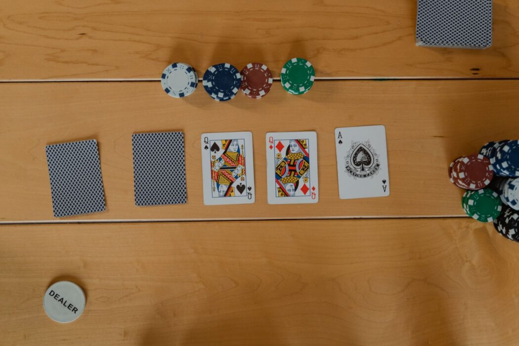 Cartes et jetons de poker disposés sur une table en bois pour jouer